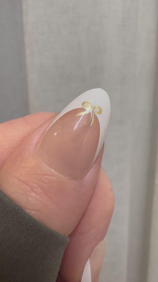 French Elegance - Gold Bow French Tip Almond Nails